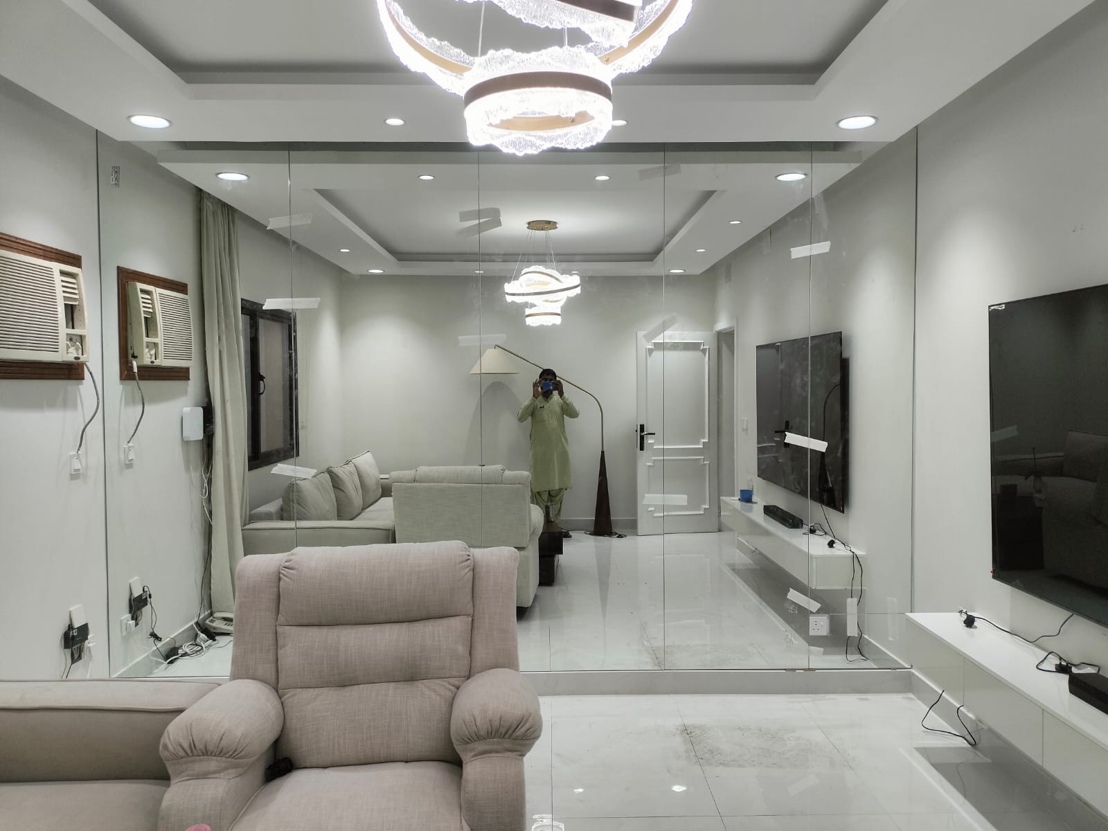 Large wall-mounted gym mirror installation